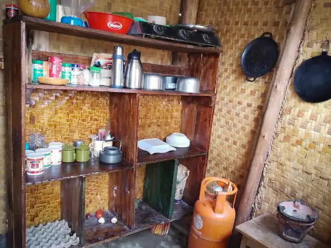 Shelves of pots and provisions in the kitchen