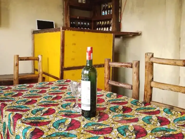 A table in patterned cloth set with wine in the bar