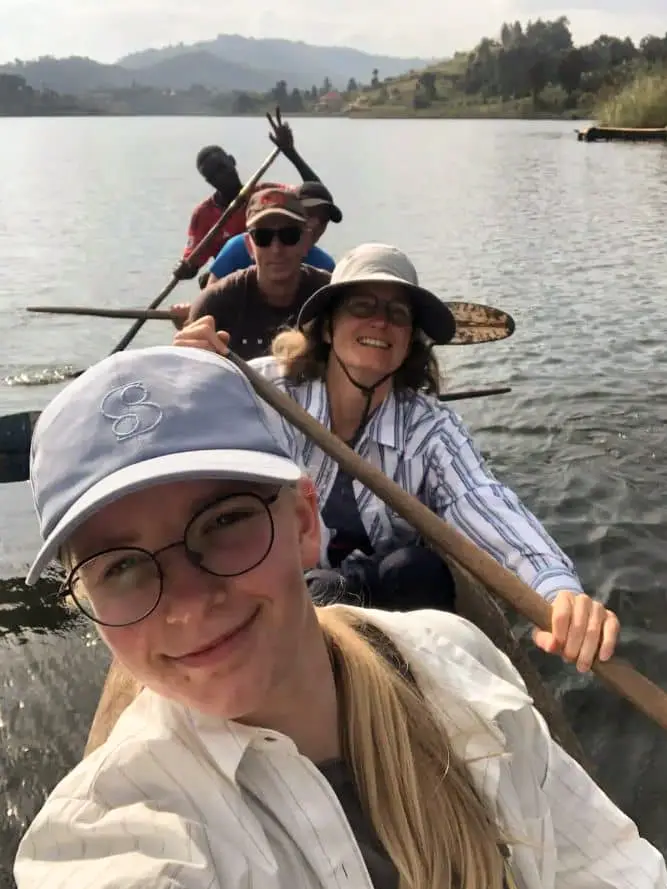 Guests paddling a dugout canoe with their guide